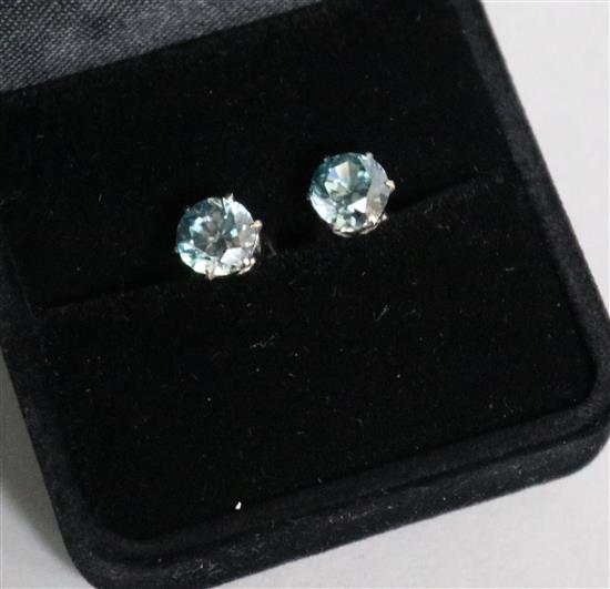 A pair of 9ct white gold and blue zircon ear studs.